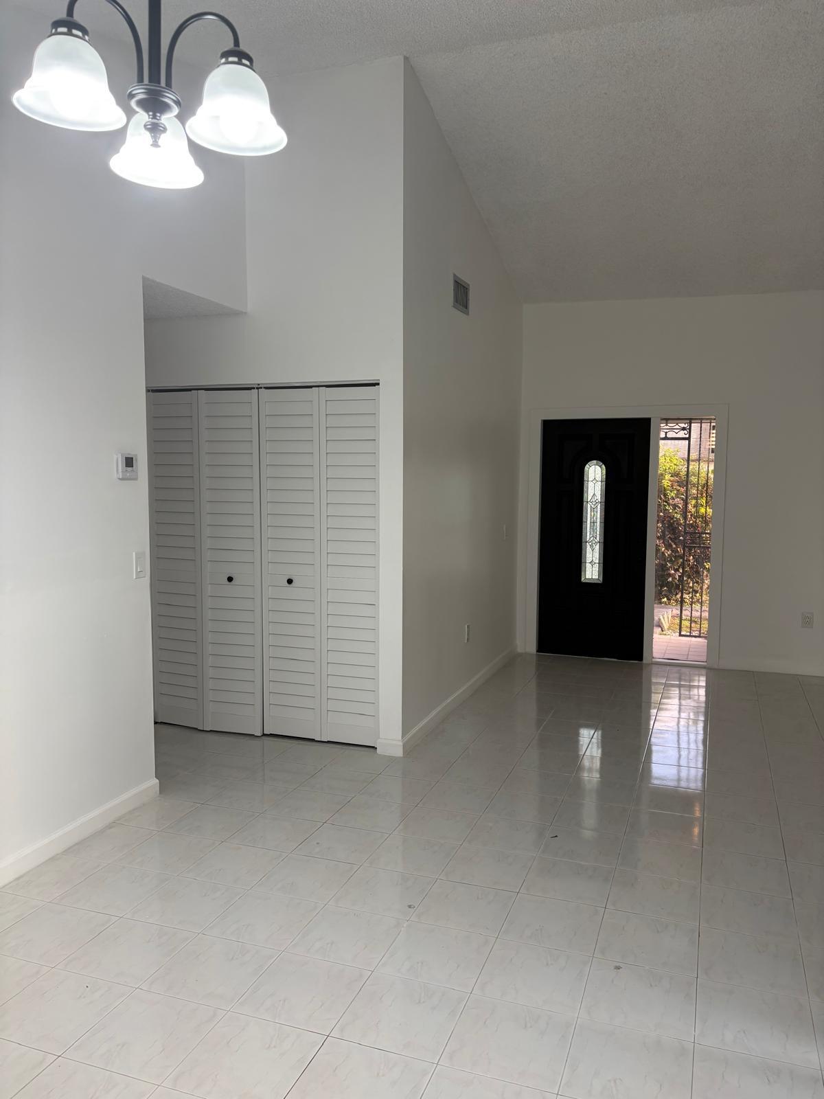 12231 Southwest 210th Street Miami, FL 33177 - Photo 8 of 38 an empty room with chandelier fan