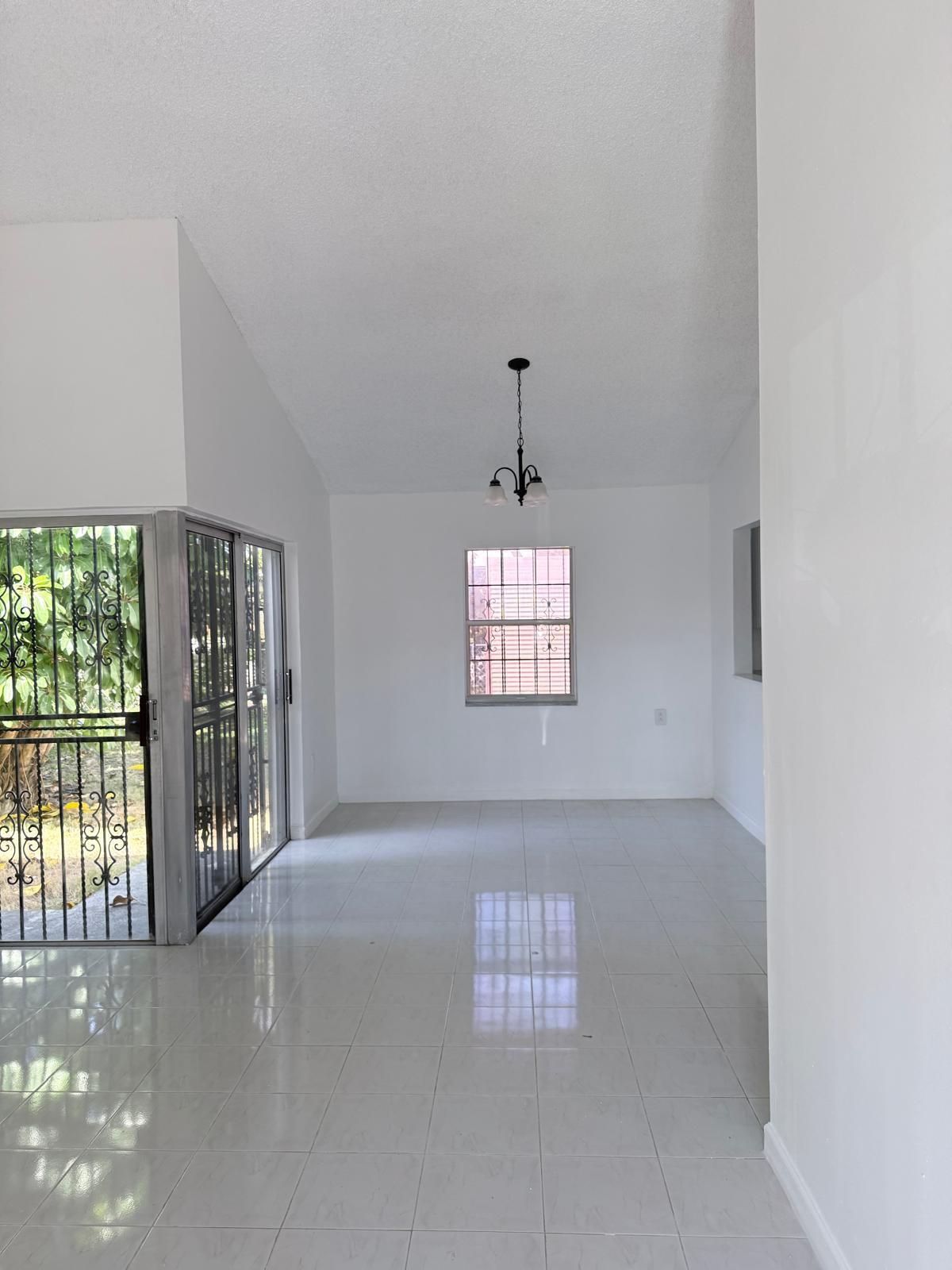 12231 Southwest 210th Street Miami, FL 33177 - Photo 9 of 38 a view of an empty room with a window