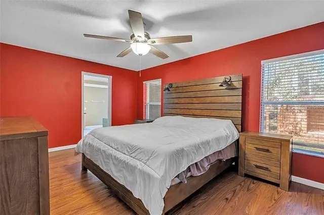 a bedroom with a large bed and a chandelier