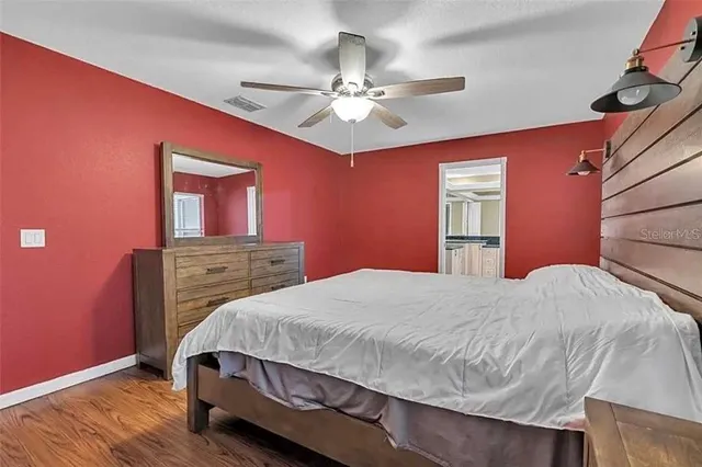 a bedroom with a bed and a chandelier