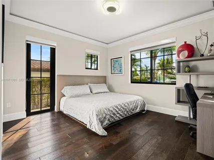 a living room with a bed furniture and a flat screen tv