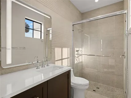 a spacious bathroom with a tub sink and mirror