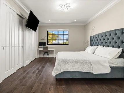 a bedroom with a large bed and a couch