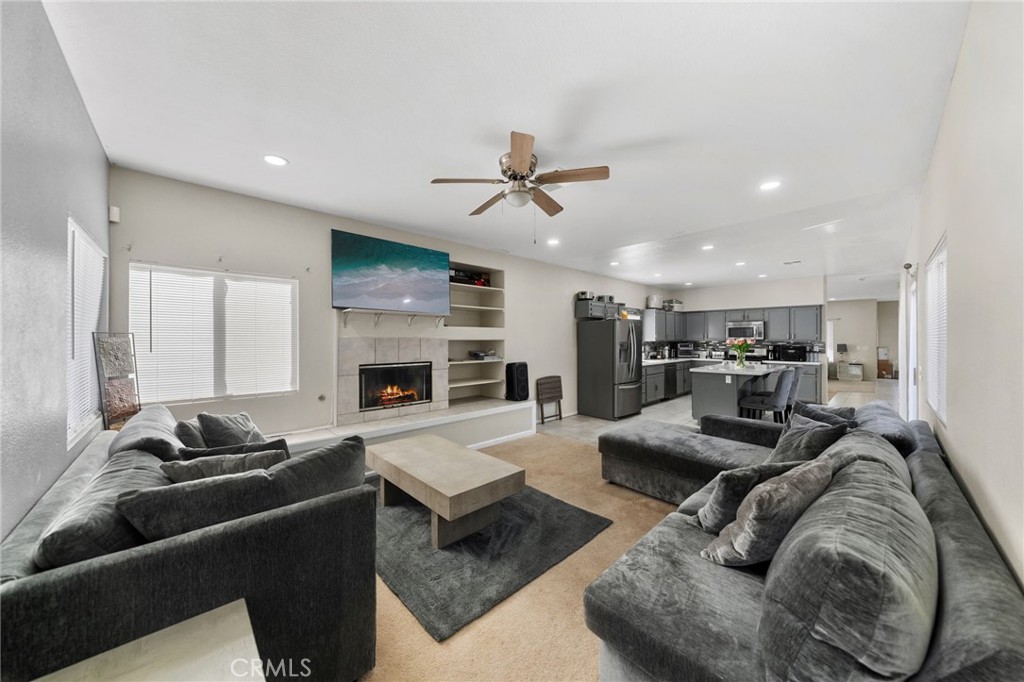 1494 Rabbit Peak Way Hemet, CA 92545 - Photo 20 of 45 a living room with furniture ceiling fan and a fireplace