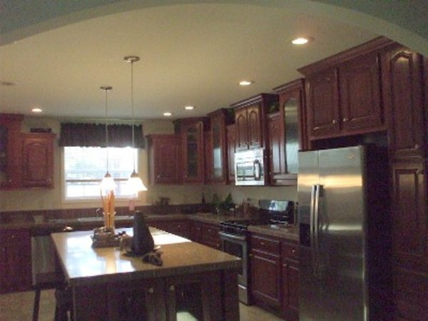 1 Acorn Street Waltham, MA 02453 - Photo 2 of 4 a kitchen with kitchen island granite countertop a sink cabinets and window