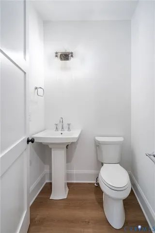 a bathroom with a sink toilet and a mirror