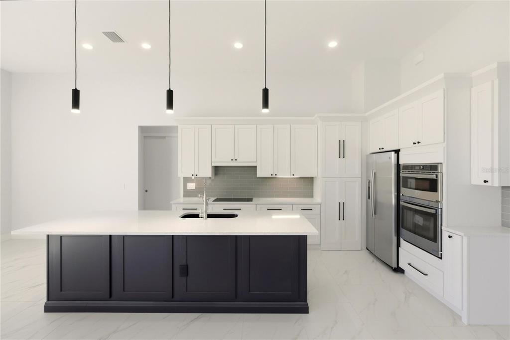 17 Long Meadow Road Rotonda West, FL 33947 - Photo 13 of 37 a kitchen with stainless steel appliances a refrigerator and a stove