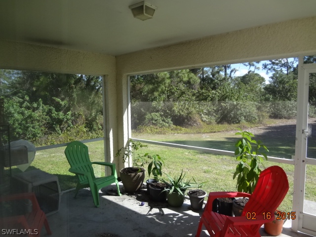 347 Ranchito Avenue Lehigh Acres, FL 33974 - Photo 8 of 18 a balcony with couple of chairs and a potted plant