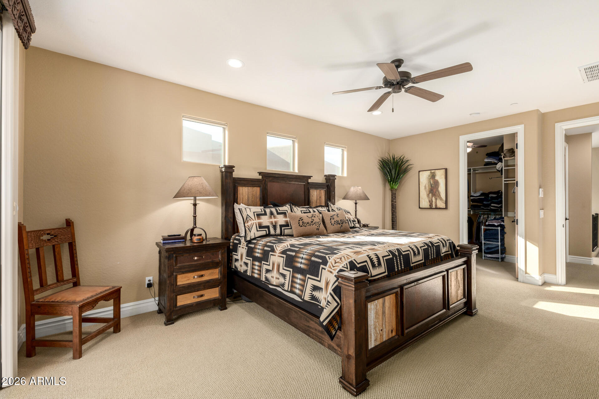 6434 East Military Road, Unit 102 Cave Creek, AZ 85331 - Photo 17 of 66 a spacious bedroom with a bed and a chandelier