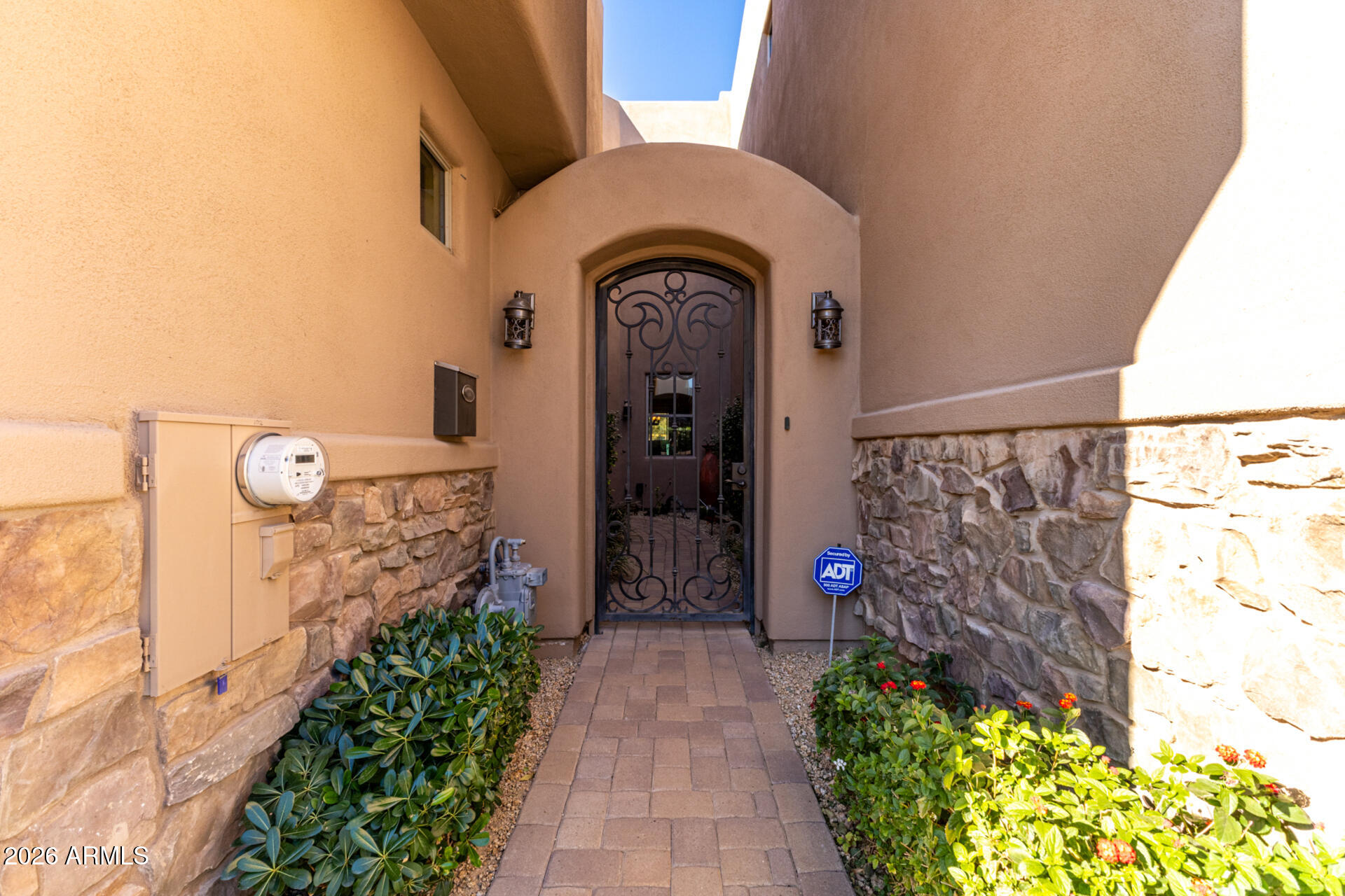 6434 East Military Road, Unit 102 Cave Creek, AZ 85331 - Photo 3 of 66 a front view of a house with a garden