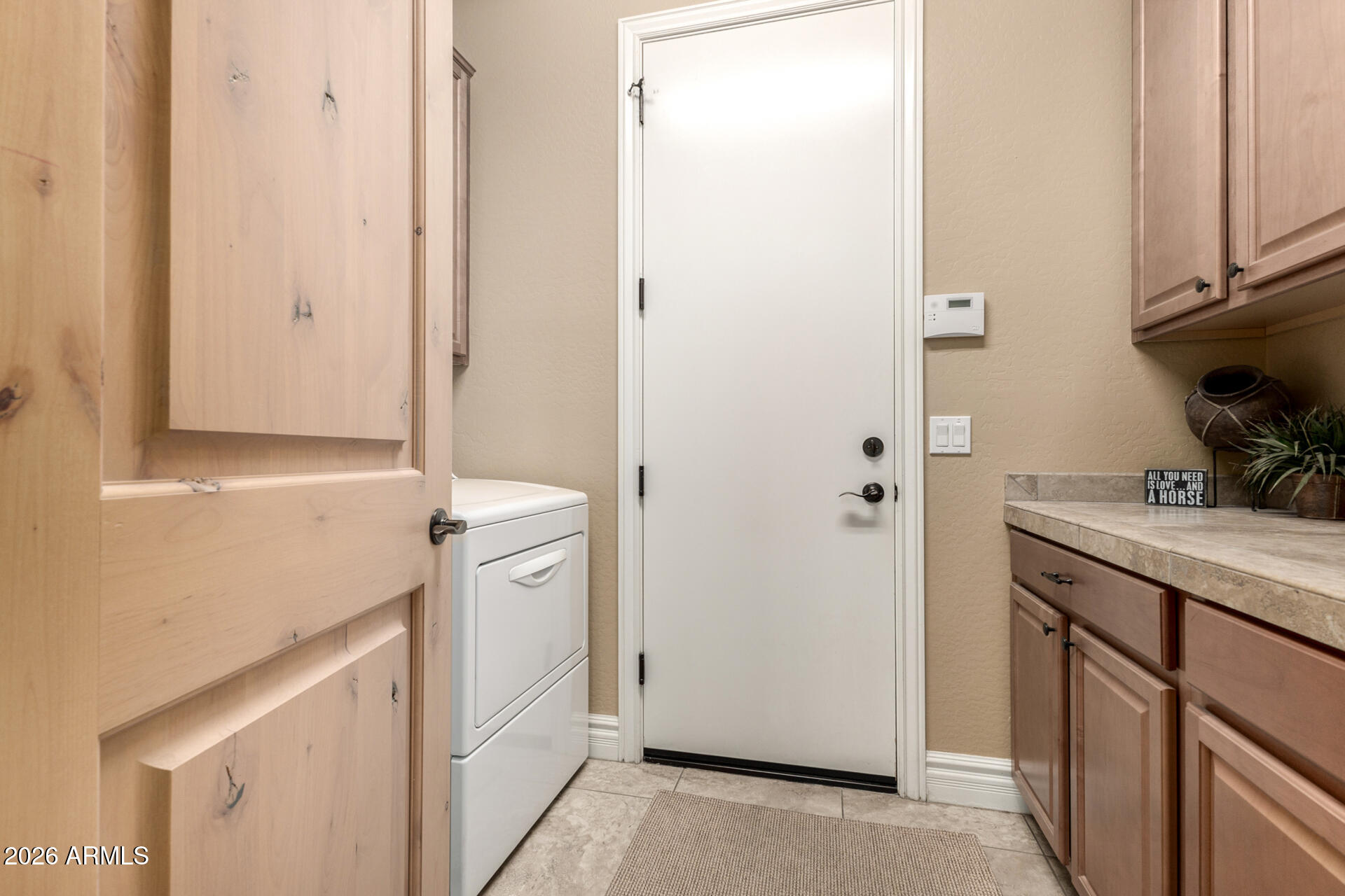 6434 East Military Road, Unit 102 Cave Creek, AZ 85331 - Photo 31 of 66 a utility room with cabinets washer and dryer