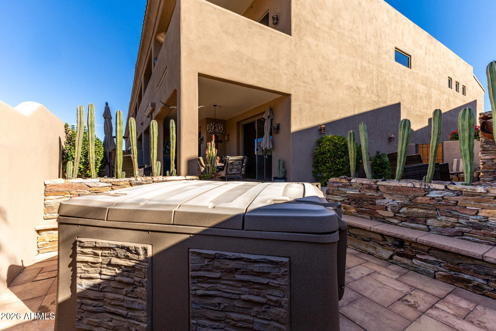 6434 East Military Road, Unit 102 Cave Creek, AZ 85331 - Photo 41 of 66 a view of a patio with a table and chairs and potted plants