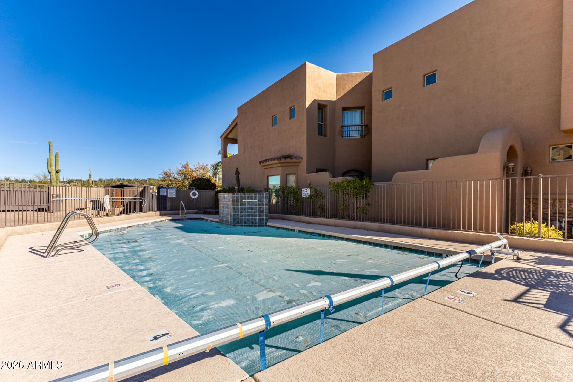 6434 East Military Road, Unit 102 Cave Creek, AZ 85331 - Photo 45 of 66 a view of a swimming pool with a lounge chairs