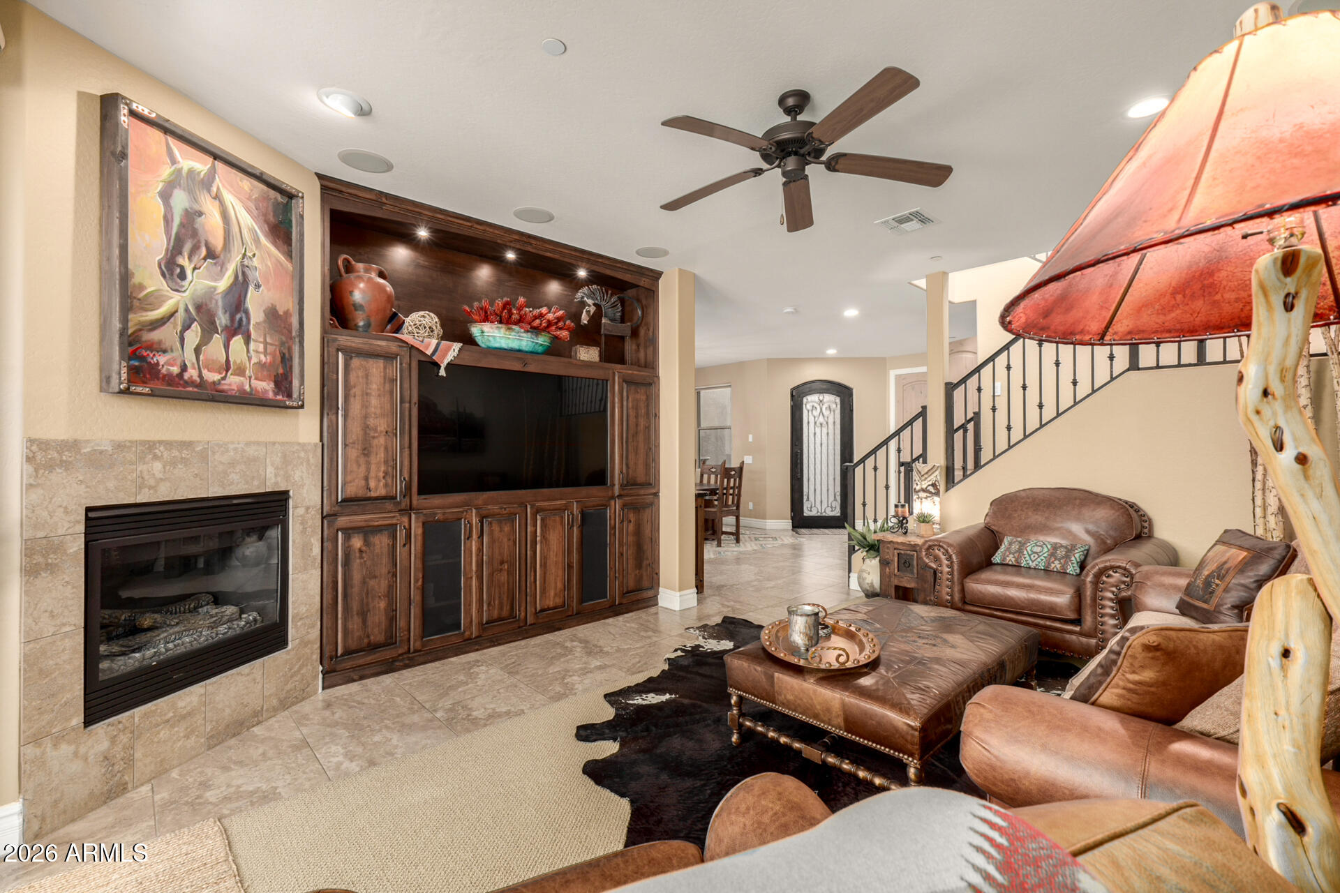 6434 East Military Road, Unit 102 Cave Creek, AZ 85331 - Photo 8 of 66 a living room with furniture a flat screen tv and a fireplace