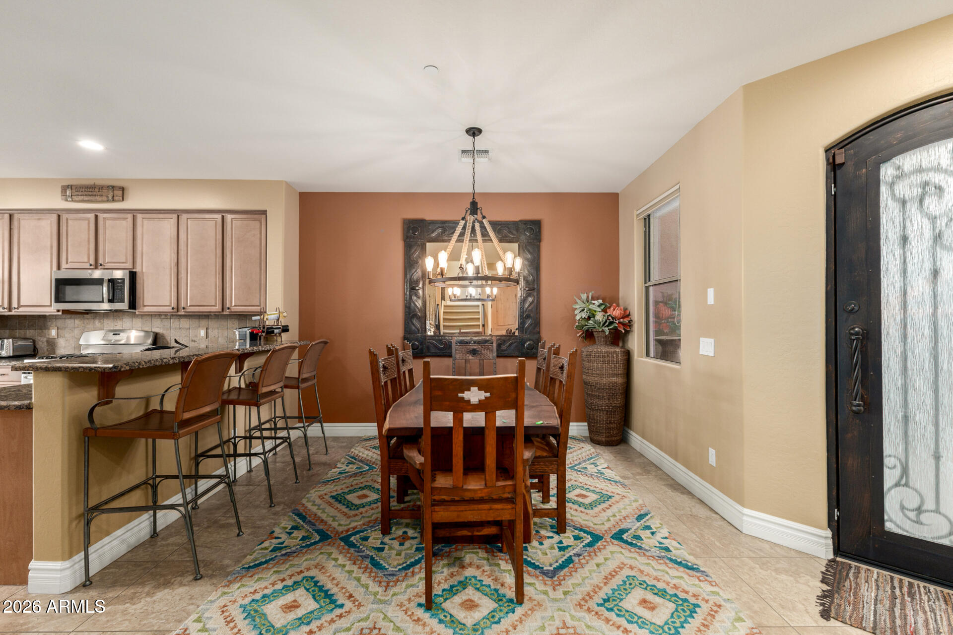 6434 East Military Road, Unit 102 Cave Creek, AZ 85331 - Photo 9 of 66 a view of a dining room with furniture window and wooden floor