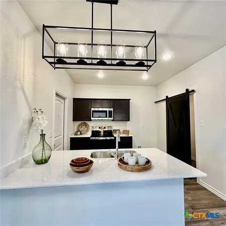 a kitchen with a sink and refrigerator