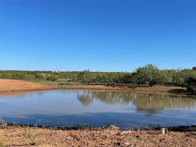 an aerial view of a house with a lake view