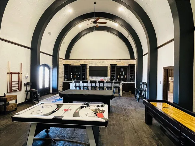 a living room with stainless steel appliances kitchen island granite countertop a stove and a refrigerator