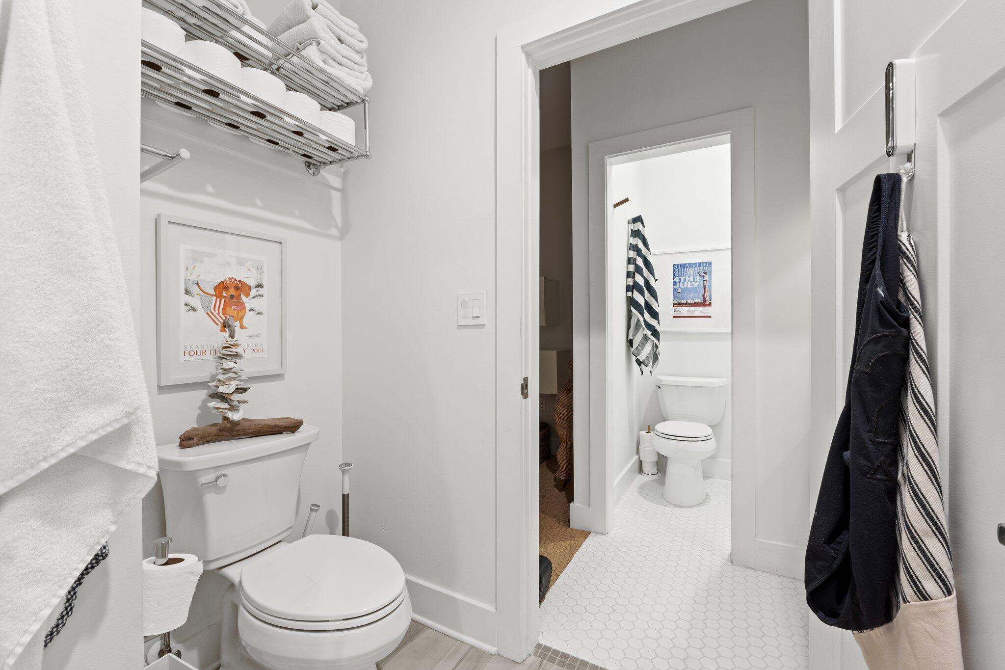 58 Cottage Way, Unit 6 Inlet Beach, FL 32461 - Photo 41 of 60 a white toilet sitting next to a bathroom sink and a mirror