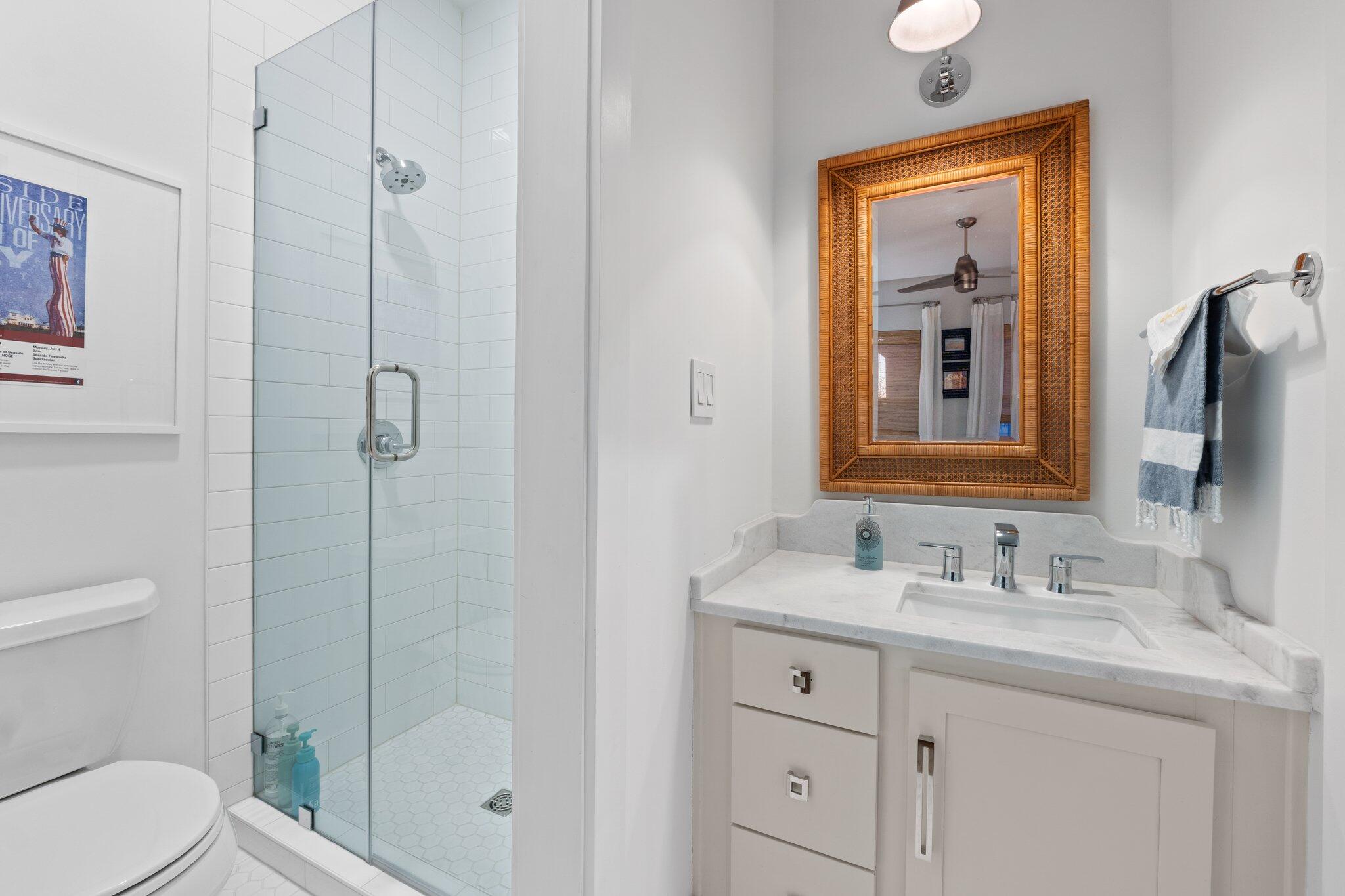 58 Cottage Way, Unit 6 Inlet Beach, FL 32461 - Photo 43 of 60 a bathroom with a granite countertop sink toilet a mirror a vanity and shower