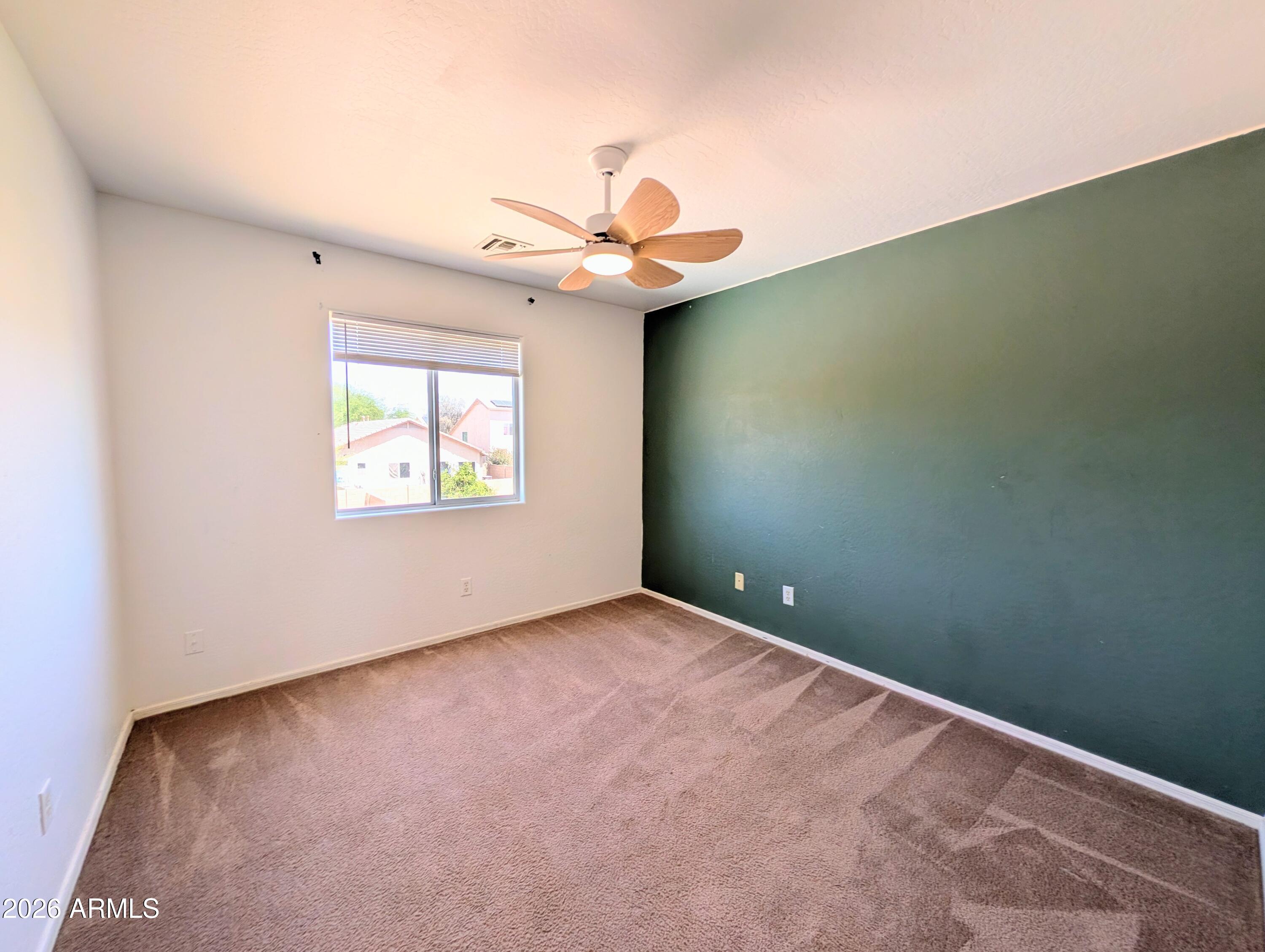 712 Baldwin Loop Coolidge, AZ 85128 - Photo 11 of 21 an empty room with a fan & a window
