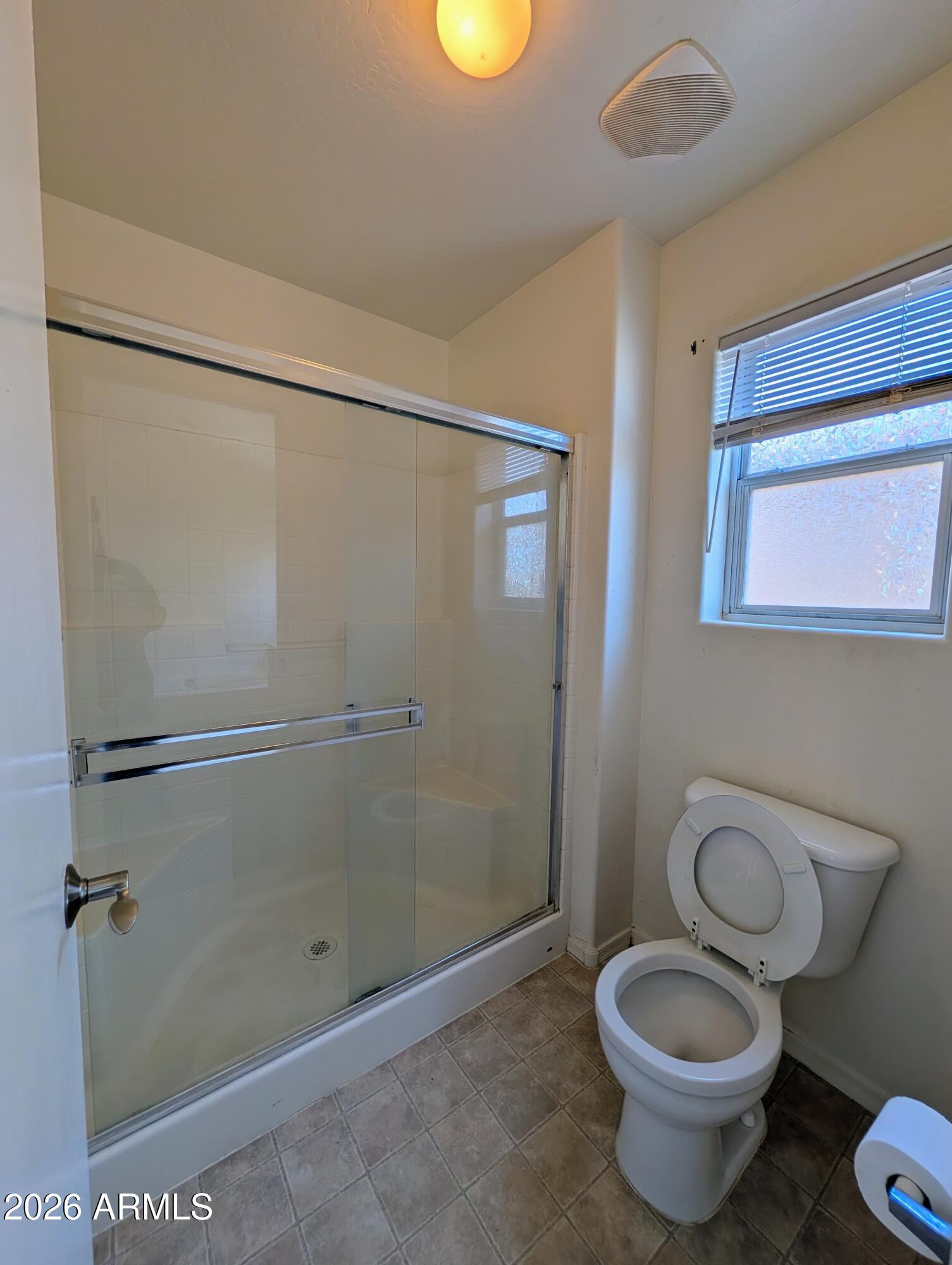 712 Baldwin Loop Coolidge, AZ 85128 - Photo 16 of 21 a bathroom with a granite countertop toilet and a shower