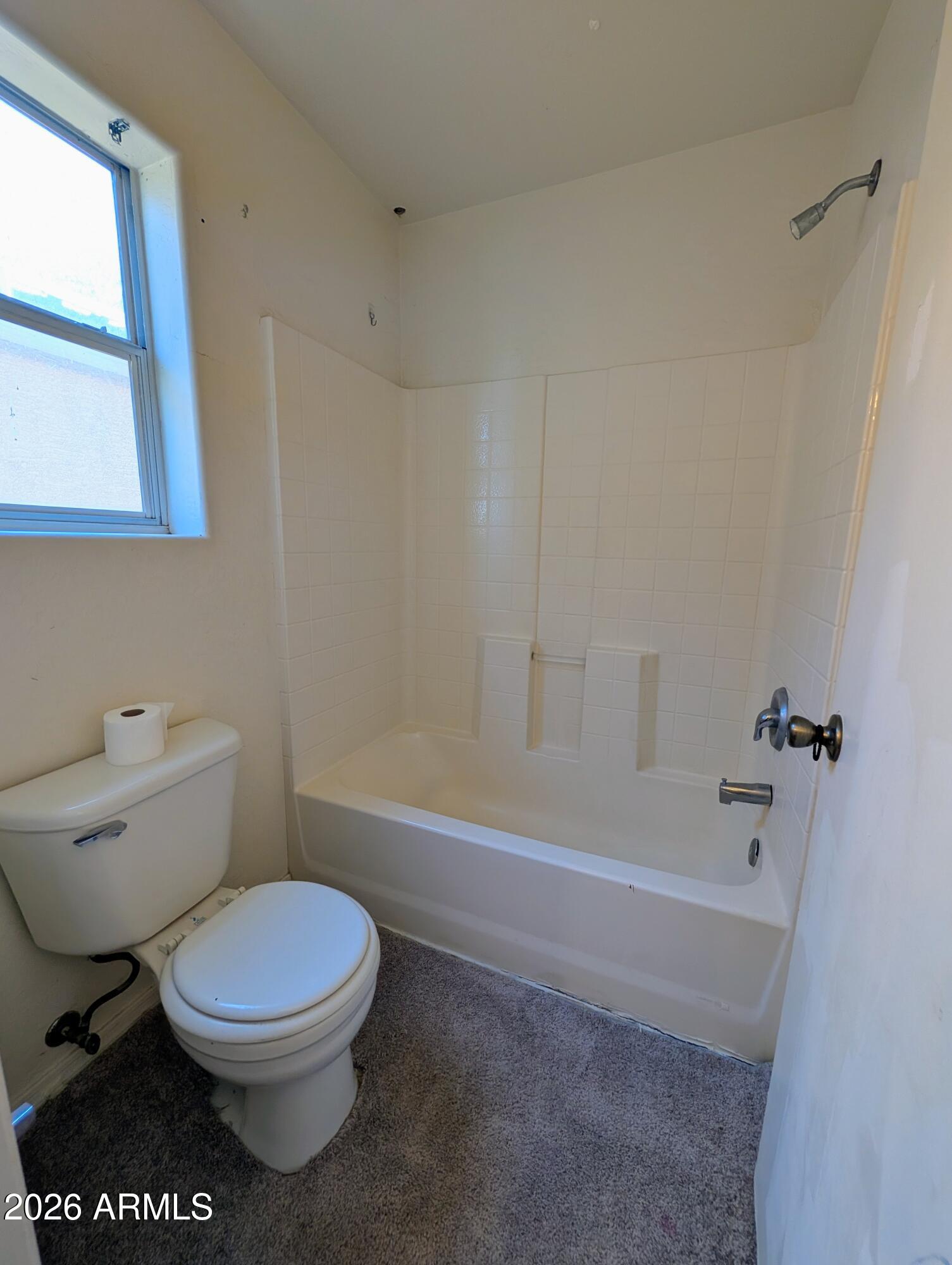 712 Baldwin Loop Coolidge, AZ 85128 - Photo 17 of 21 a bathroom with a toilet a sink and bathtub