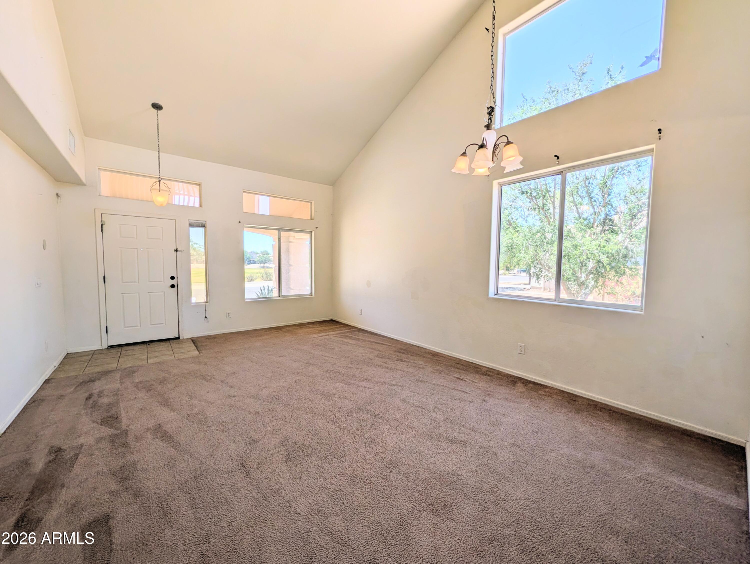 712 Baldwin Loop Coolidge, AZ 85128 - Photo 2 of 21 a view of a big room with windows and chandelier fan