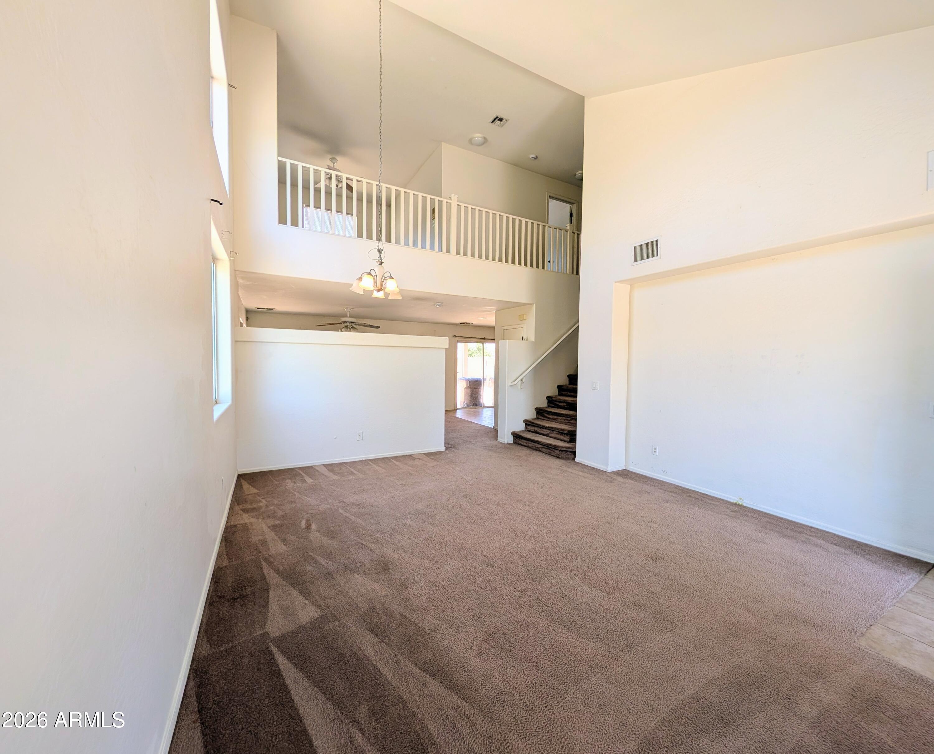 712 Baldwin Loop Coolidge, AZ 85128 - Photo 5 of 21 a view of a hallway to an empty room