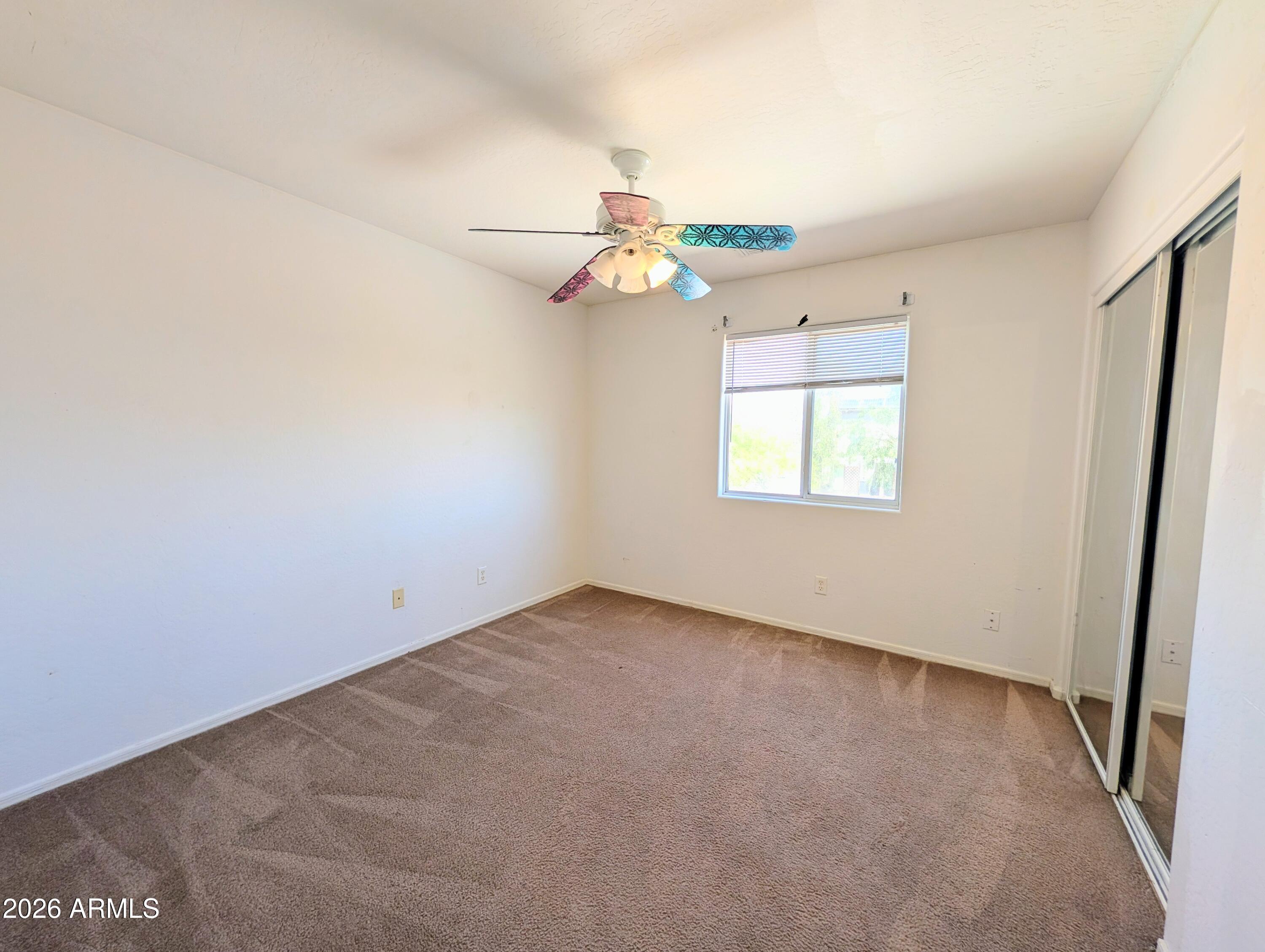 712 Baldwin Loop Coolidge, AZ 85128 - Photo 10 of 21 an empty room with windows and fan