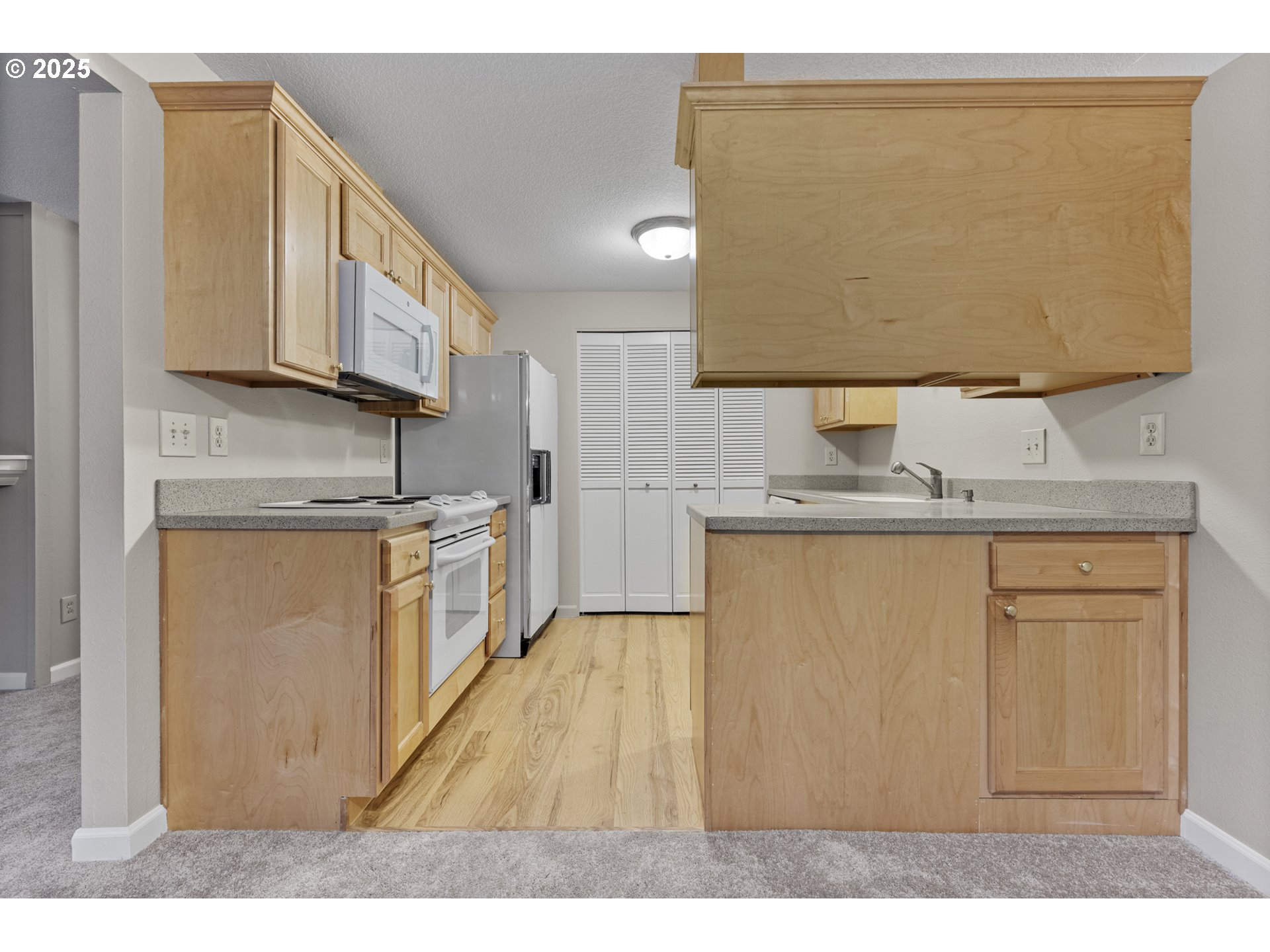 7112 Southwest Murray Boulevard Beaverton, OR 97008 - Photo 11 of 40 a kitchen with stainless steel appliances granite countertop a sink and a refrigerator