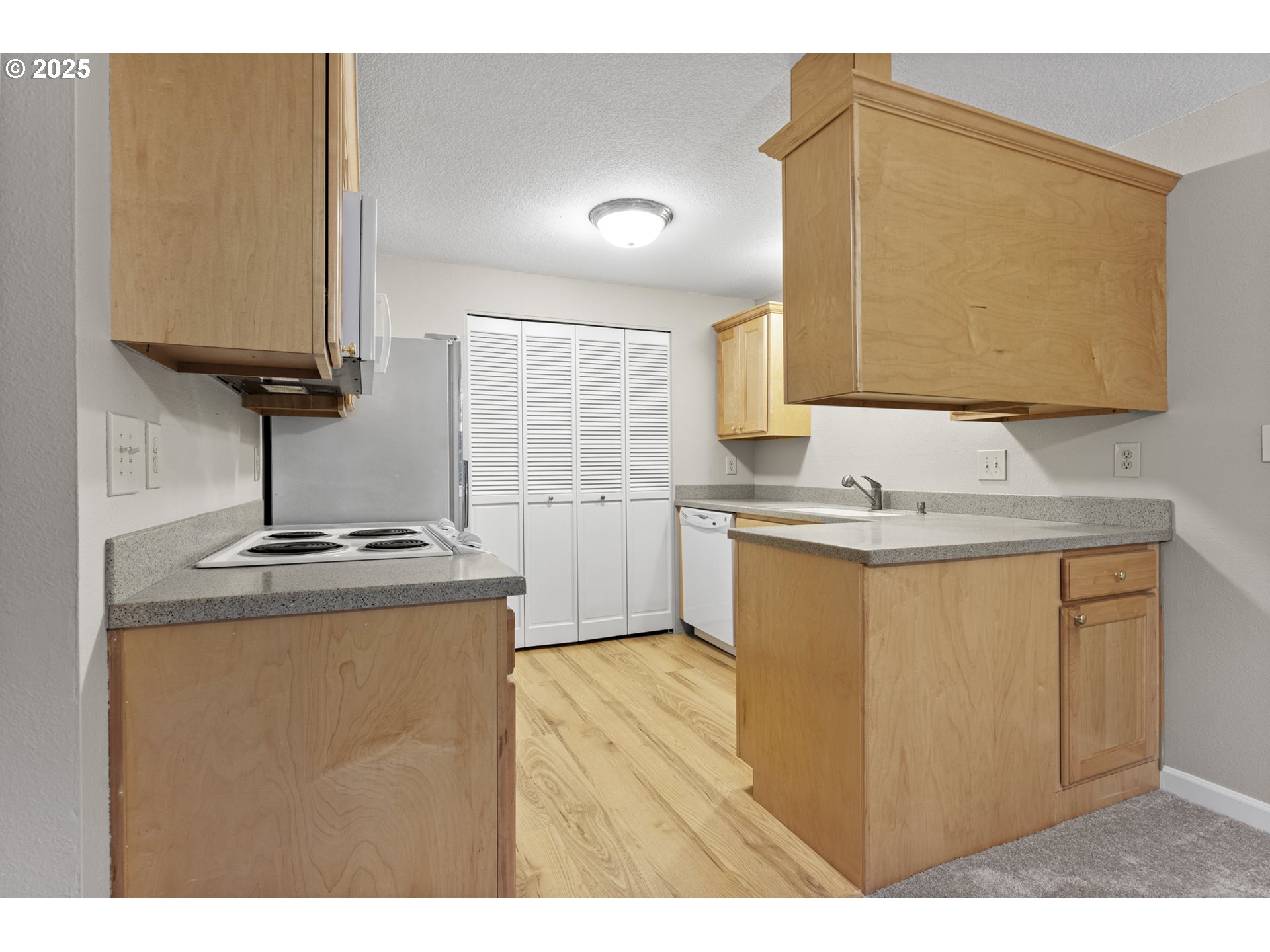 7112 Southwest Murray Boulevard Beaverton, OR 97008 - Photo 12 of 40 a kitchen with kitchen island a sink stainless steel appliances and cabinets