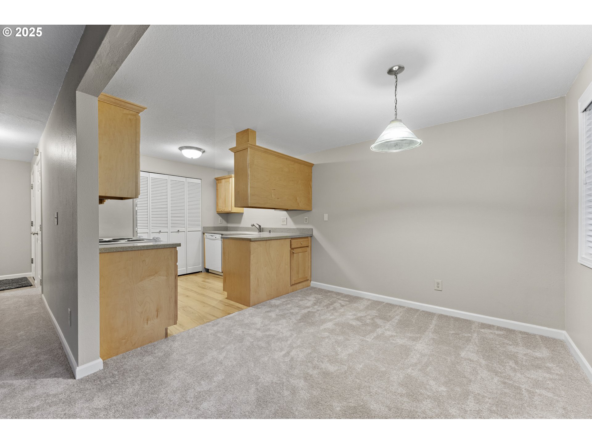 7112 Southwest Murray Boulevard Beaverton, OR 97008 - Photo 13 of 40 a kitchen with kitchen island stainless steel appliances a stove refrigerator sink and fireplace