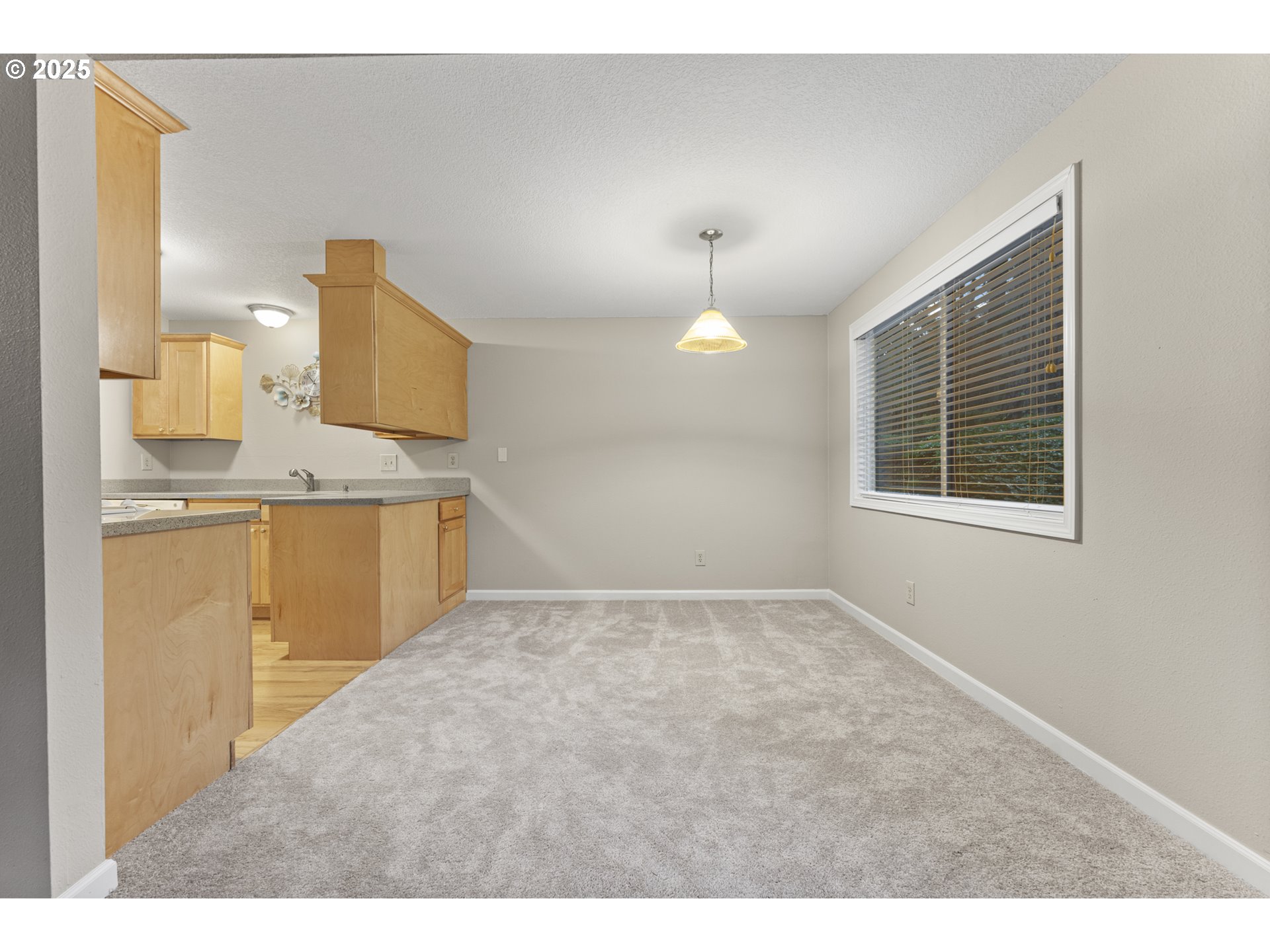 7112 Southwest Murray Boulevard Beaverton, OR 97008 - Photo 21 of 40 a view of kitchen and empty room with wooden floor