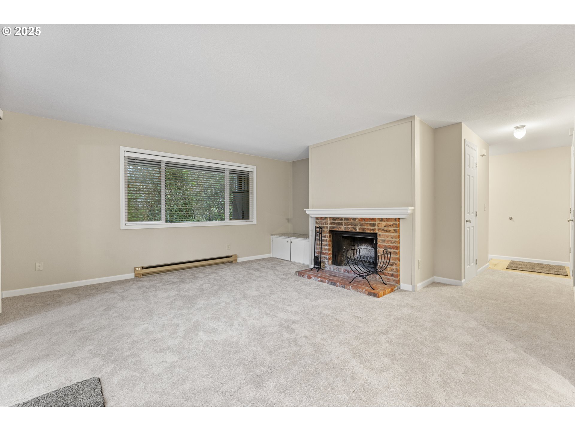 7112 Southwest Murray Boulevard Beaverton, OR 97008 - Photo 7 of 40 a view of an empty room with a window and a fireplace
