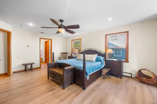 a bedroom with furniture and wooden floor