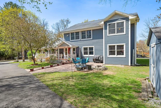a view of a house with backyard sitting area and garden