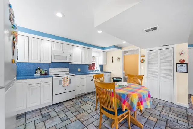 a kitchen that has a lot of cabinets in it and appliances
