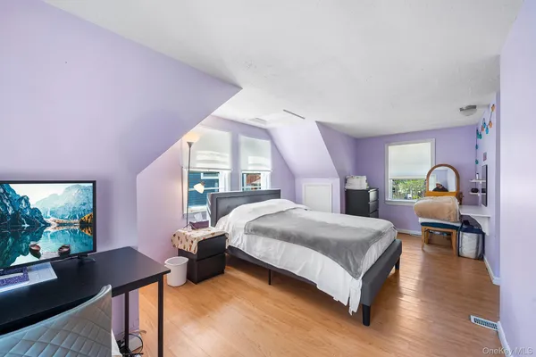 a bed room with a bed and a chair