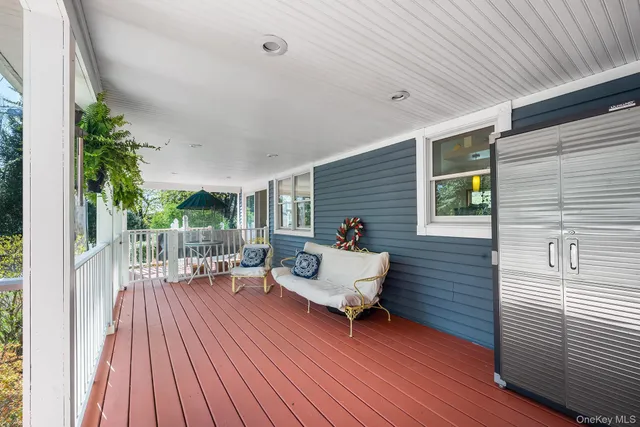 a balcony with wooden floor and furniture