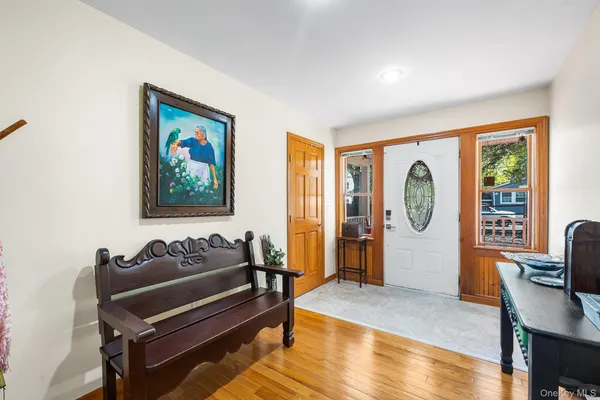 a view of entryway and hall with wooden floor