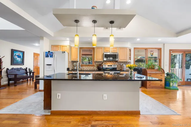 a view of a living room and kitchen floor to ceiling window and kitchen view