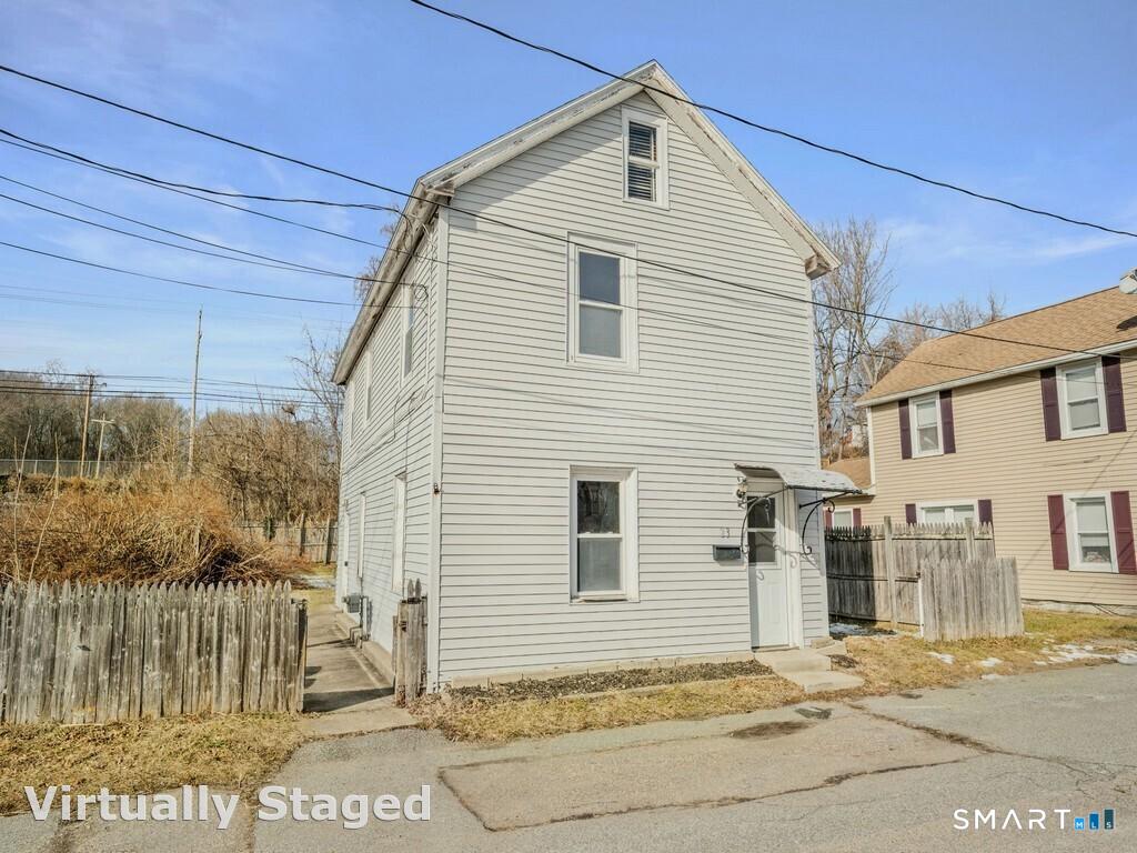 a view of a house with a wooden fence