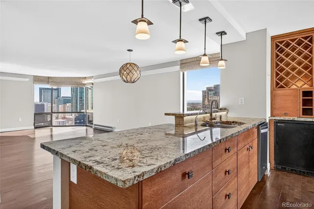 a bathroom with a granite countertop sink and a large mirror