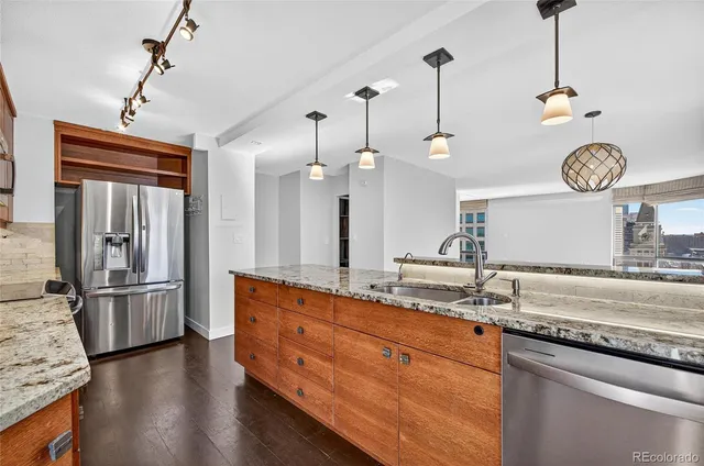 a kitchen with a refrigerator a sink and dishwasher