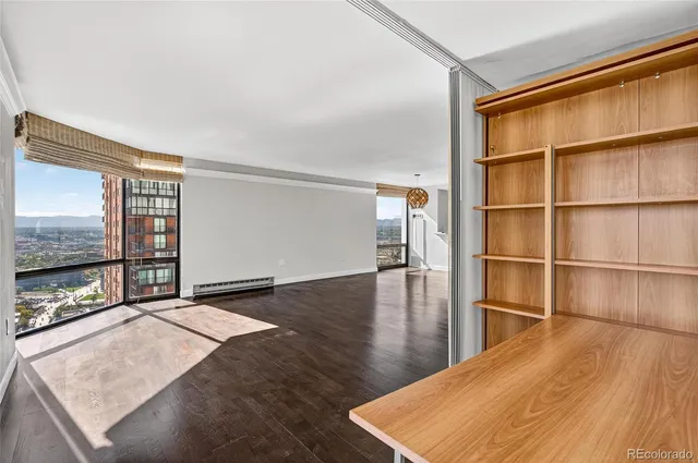 a room with a wooden floor and a large window