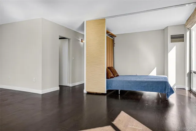 a room with wooden floor and furniture