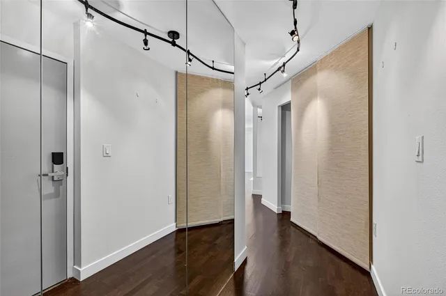 a view of a very nice looking hallway with wooden floor