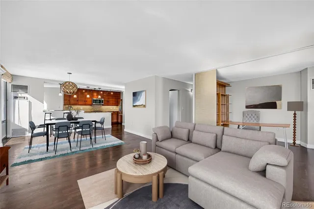 a living room with furniture a dining table and kitchen view