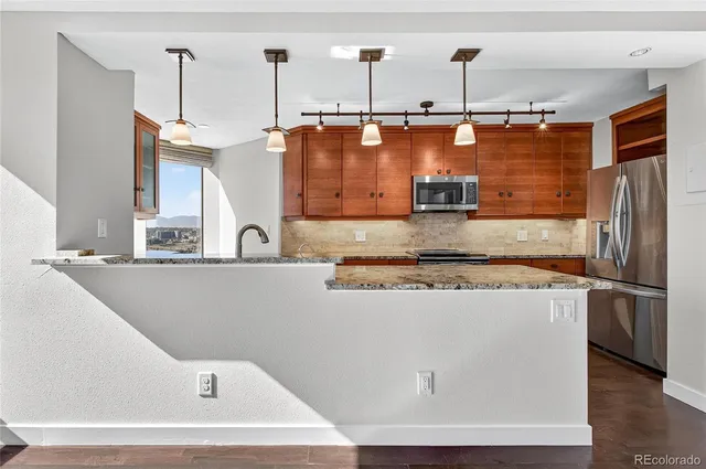 a view of a kitchen with a sink a refrigerator and window